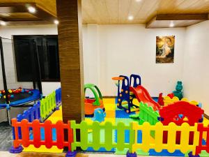 a childrens play room with a toy playground at Aachman Nature Valley Resort Shimla in Shimla