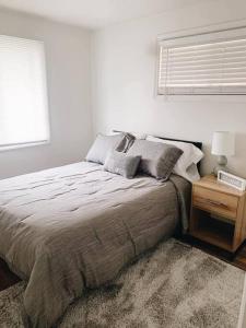 a bedroom with a bed and a window and a nightstand at Stylish & Cozy Home in Dayton-Close to Everything! in Dayton