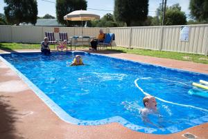 a couple of people in a swimming pool at Artesian Motor Inn in Coonamble
