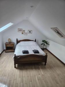 a bedroom with a bed and a wooden floor at La petite bulle in Villeneuve-sur-Yonne +8 photos