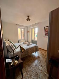 a bedroom with a bed and a lamp on a table at RioRooms La Valletta Riomaggiore Center in Riomaggiore +24 photos