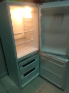 an empty refrigerator with its door open in a kitchen at The Rosebank Mall Place in Johannesburg