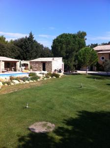 um quintal com uma casa e uma piscina em Le carpe noctem em Sérignan-du-Comtat