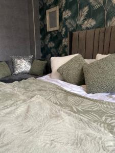 a white bed with pillows on top of it at Cozy Downtown Studio Flat in Sheffield in Sheffield