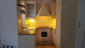 a small kitchen with a stove and a sink at Chata Remata 879 in Handlová
