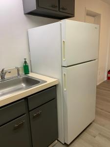 a kitchen with a white refrigerator and a sink at Central Bellevue Guesthouse in Bellevue