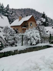 a house with a fence covered in snow at Chata Remata 879 in Handlová