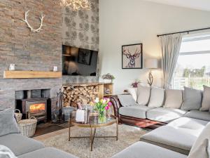 a living room with couches and a fireplace at 6 Bed in South Queensferry 94359 in Broxburn