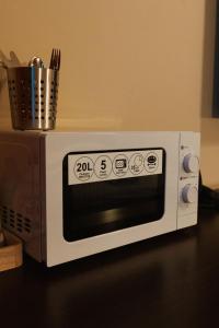 a microwave oven sitting on top of a counter at Apartmán na Hlavnej ulici in Košice +3 photos