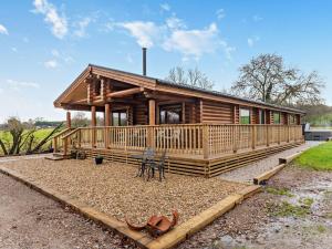 a log cabin with a porch and chairs in front of it at 3 Bed in Brinsley 93794 