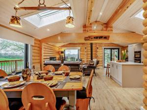 a dining room and kitchen with a table and chairs at 3 Bed in Brinsley 93794 