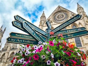 a street sign in front of a cathedral with flowers at 3 Bed in Tollerton 93896 in Tollerton