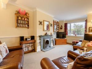 a living room with a couch and a fireplace at 3 Bed in Portinscale 93949 in Portinscale