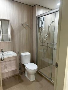 a bathroom with a shower and a toilet and a sink at Cozy Homely Studio @ Youth City Residence Nilai in Nilai