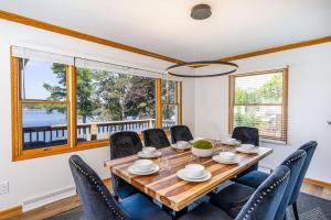 a dining room with a wooden table and chairs at 5BR Lakefront Getaway with hot tub in Cadillac