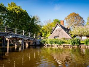 a bridge over a river next to a house at 3 Bed in Dedham 94016 in Dedham