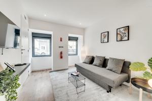 a living room with a couch and a table at Lapa Stylish Apartments in Lisbon