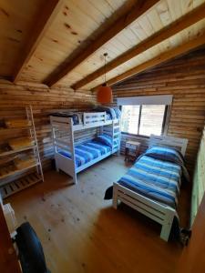 1 dormitorio con 2 literas en una cabaña de madera en Complejo AIKA - Balneario Marisol - Oriente, en Balneario Oriente