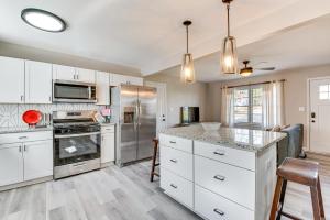 a kitchen with white cabinets and stainless steel appliances at Pet-Friendly Mableton Home with Grill and Fire Pit! in Mableton