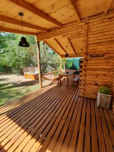 una terraza de madera con una mesa de picnic. en Complejo AIKA - Balneario Marisol - Oriente, en Balneario Oriente