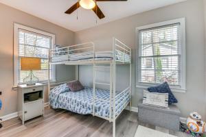 a bedroom with a bunk bed and two windows at Pet-Friendly Mableton Home with Grill and Fire Pit! in Mableton