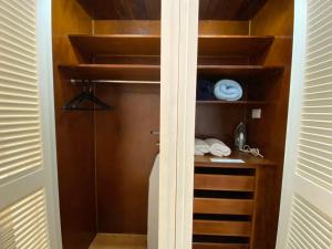 a closet with wooden shelves in a room at Suite HotelCCT in Caracas