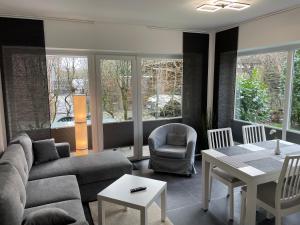 a living room with a couch and a table at Strandhaus am Kurpark in Cuxhaven