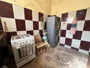 a kitchen with a stove and a refrigerator at Thraa - ثراء in Siwa