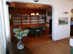 une salle à manger avec une table et un vase de fleurs dans l'établissement Residance Park, à Grignano