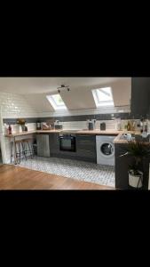 a kitchen with a sink and a stove top oven at The Annex at Kronstad in Stroud