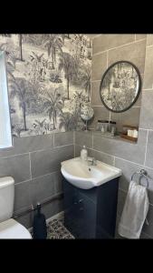 a bathroom with a sink and a mirror at The Annex at Kronstad in Stroud