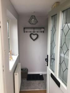 a bathroom with a heart sign on the wall at The Annex at Kronstad in Stroud
