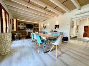 a dining room with a wooden table and chairs at Villa Sun Club home in Llucmajor