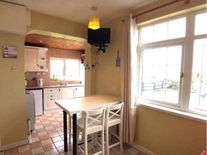 a kitchen with a table and a window at Rossnowlagh Creek Chalet 6 in Rossnowlagh