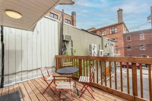 a patio with a table and chairs on a deck at Le Alexis, A stay in the heart of the City ! in Quebec City