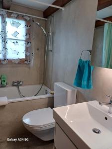 een badkamer met een toilet, een bad en een wastafel bij Afrika Zimmer mit Bergblick in Emmetten