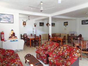 a living room with couches and a dining room at Wellawaya Rest House in Wellawaya +21 photos