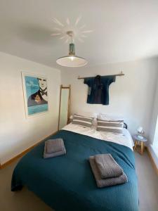 a bedroom with a large bed with a blue blanket at St Benedicts Street Flat with Roof Terrace in Norwich