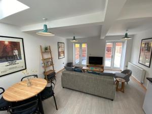 a living room with a couch and a table at St Benedicts Street Flat with Roof Terrace in Norwich