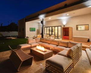 a living room with a couch and a fire pit at Hillside Mansion-Pool/Cold Plunge/Sauna-Mtn Views in Scottsdale