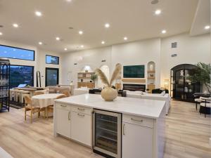 a living room with a kitchen and a dining room at Hillside Mansion-Pool/Cold Plunge/Sauna-Mtn Views in Scottsdale