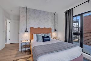 a bedroom with a large bed and a large window at Hyve-The Cosmo-Walk To Broadway in Nashville