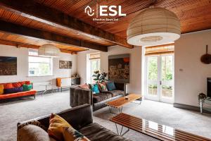 a living room with couches and a table at 3 Bedroom House - Overlooking River - Shrewsbury Town Centre in Shrewsbury