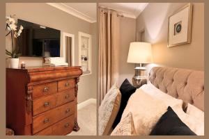 a bedroom with a bed and a dresser with a mirror at The Richmond Retreat in New Malden