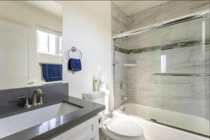 a bathroom with a sink and a toilet and a shower at Cheerful 5BR house with parking near USC in Los Angeles