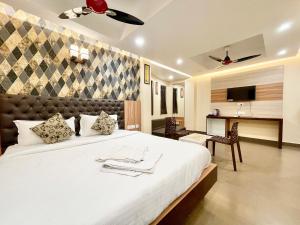 a bedroom with a large white bed in a room at Hotel Yashasvi inn ! Puri near-sea-beach-and-temple fully-air-conditioned-hotel with-lift-and-parking-facility breakfast-included in Puri