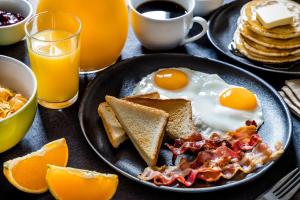 a plate of breakfast food with eggs and toast at Le Refuge de Manou in Saint-Péray