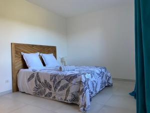 a bedroom with a large bed with blue sheets and white pillows at Casa Laura in Cervione +3 photos