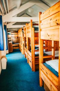 a row of bunk beds in a room at Denton House Hostel in Keswick