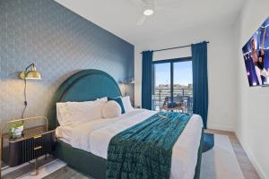 a bedroom with a large bed and a large window at Hyve - The Peacock - Walk to Broadway in Nashville